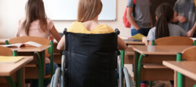 Teenage,Girl,In,Wheelchair,With,Classmates,At,School